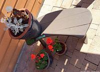 bench with large planter on top and two smaller planters below