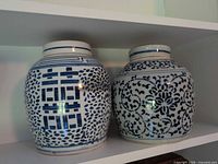 Front view of both ginger jars showing motifs