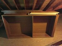 Bookshelf frame on its side with loose shelf boards