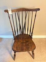 Front view of dark wood Windsor fan back chair