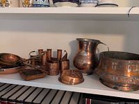 Group view of all copper items on shelf