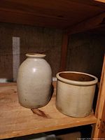 Front view of both crocks on shelf