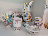 Five ceramic pieces grouped: Spanish jug, Deruta pitcher, Deruta jar, Portuguese cup, Herend basket