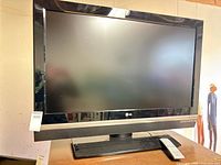 Front view of LG television and remote on stand