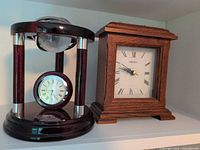 Front view of both mantel clocks on shelf
