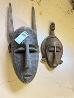 Front view of both masks hung on wall