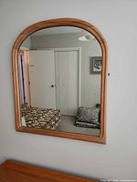Full view of arch-top mirror on wall