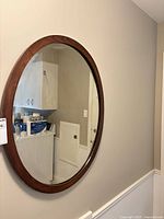 Front view of oval mirror on wall