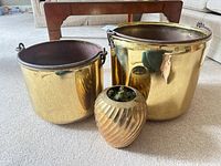 Front view of two planters and ribbed vase