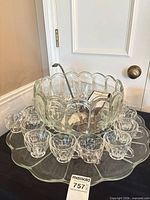 Full set showing bowl on underplate with 16 cups arranged and ladle inserted