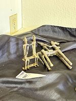 Both Dogon bronze sculptures on cloth backdrop