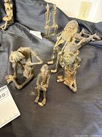 Group of seven Dogon bronze figures on fabric backdrop
