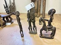 All three Dogon carved wooden figures grouped together