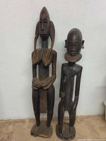 Full view of both Bamana wooden sculptures standing side by side