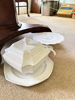 White ceramic soup tureen with underplate and milk glass cake plate visible