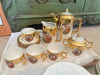 Group view of gold-plated Versailles porcelain tea set pieces