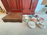 Overall lot showing wooden box and eight teacup & saucer sets
