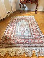 Full view of silk prayer rug showing overall design and colors