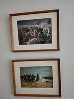 Both framed prints hanging on wall