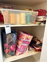 Cabinet shelf with bin of ribbons, gift bags and boxes