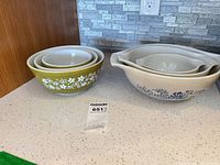 Both Pyrex bowl sets nested on countertop