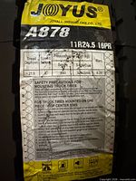 Factory spec label on Joyall A878 tire showing size, ply, tread depth and pressure ratings