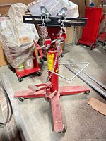 Full view of transmission jack showing frame, saddle, chains and caster base