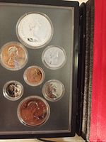 Coins displayed in holder inside case, showing obverse designs