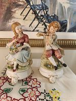 Front view of both Andrea figurines on bases