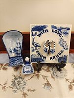 Full lot showing tile, wall pocket and figurine