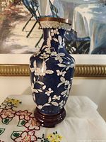 Full view of cloisonné vase on wood stand