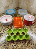 All six items arranged on countertop showing lids and molds