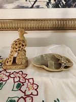 Both soapstone items side by side on cloth