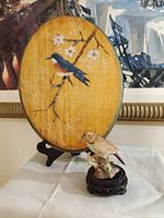 Full view of plaque on easel and figurine on stand