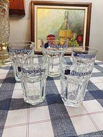 Five Hoegaarden logo glasses on table