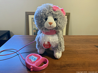 Front view of plush cat and controller