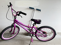 Full view of bicycle and scooter leaning against wall