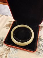 jade bangle inside red presentation box