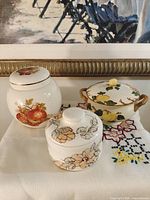 All three covered jars displayed together