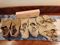 All four pairs displayed: Bloch leather shoes, pink slippers, two Capezio Foot Undeez pairs