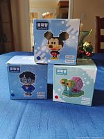 Stacked view of three Tong Meng Zhi boxed micro block sets