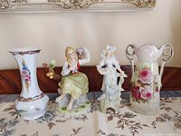 Group shot showing both figurines and both vases