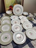 Front view of assorted plates, bowls, cups, saucers, creamer