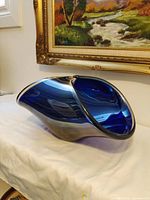 Side perspective of cobalt blue art glass bowl showing overall sculptural form