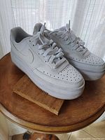 Side and top view of the white Nike Air Force 1 Low sneakers showing overall condition