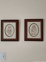Both framed prints displayed side by side on wall