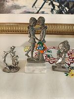 Front view of all three pewter figurines showing size and layout