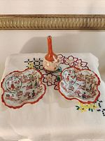Overall view of two bowls and vase on cloth