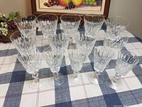 12 clear crystal wine glasses displayed on table