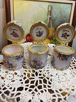 All three porcelain trinket boxes open showing interiors and inscriptions